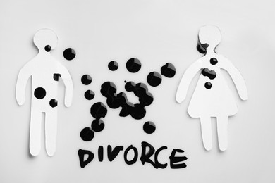Photo of Paper human figures, ink drops and word Divorce on white background, flat lay