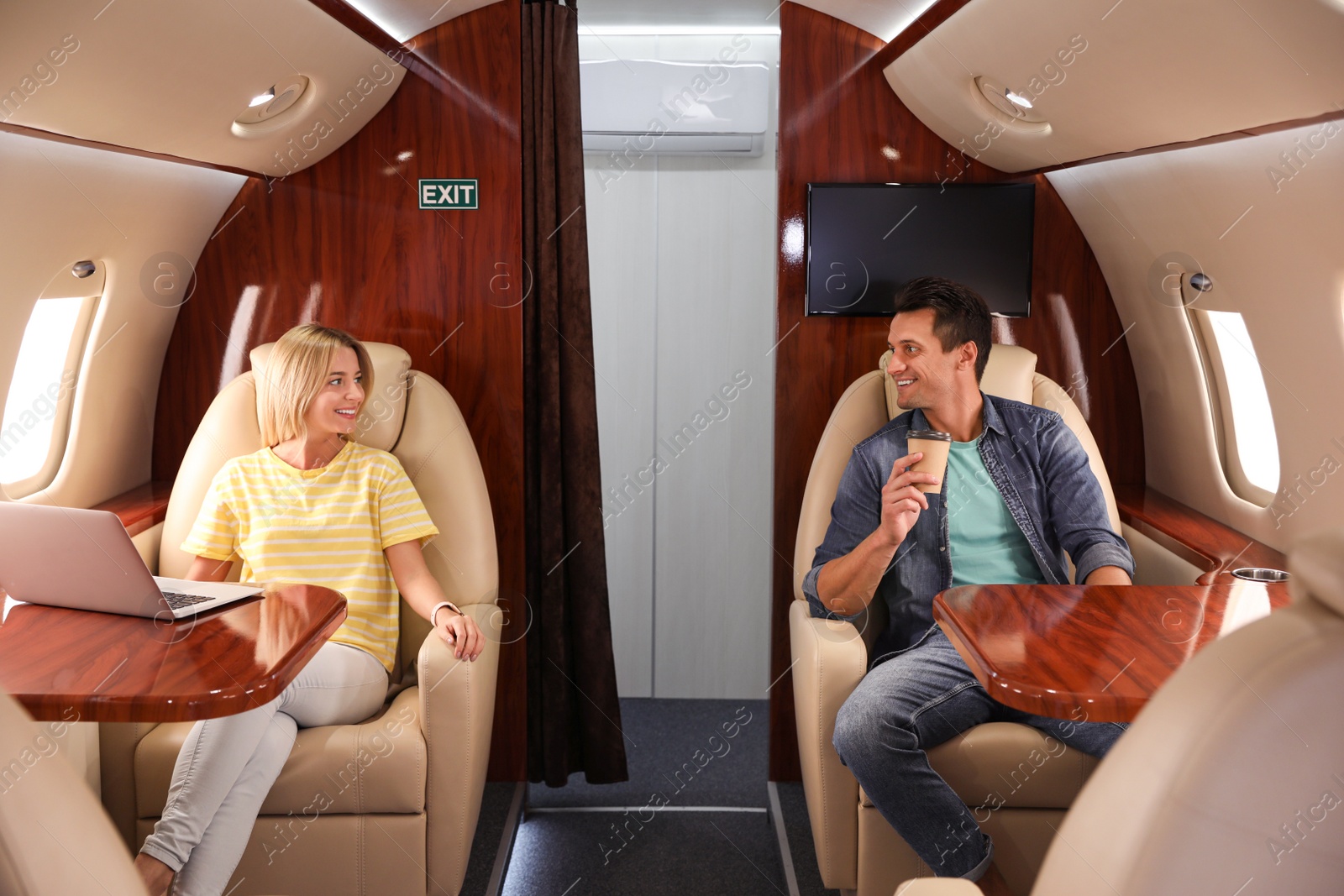 Image of Man and woman on plane. Comfortable flight