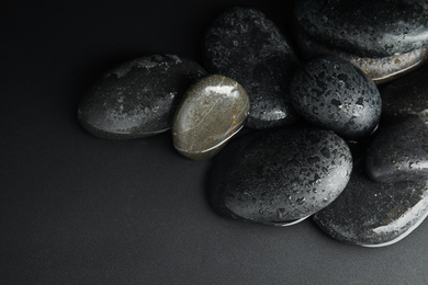 Stones in water on black background. Zen lifestyle