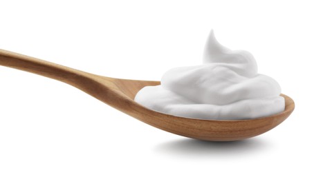 Photo of Wooden spoon with sour cream isolated on white