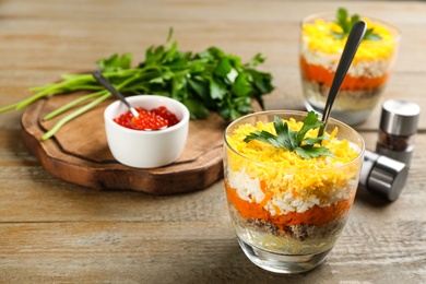 Traditional russian salad Mimosa served on wooden table