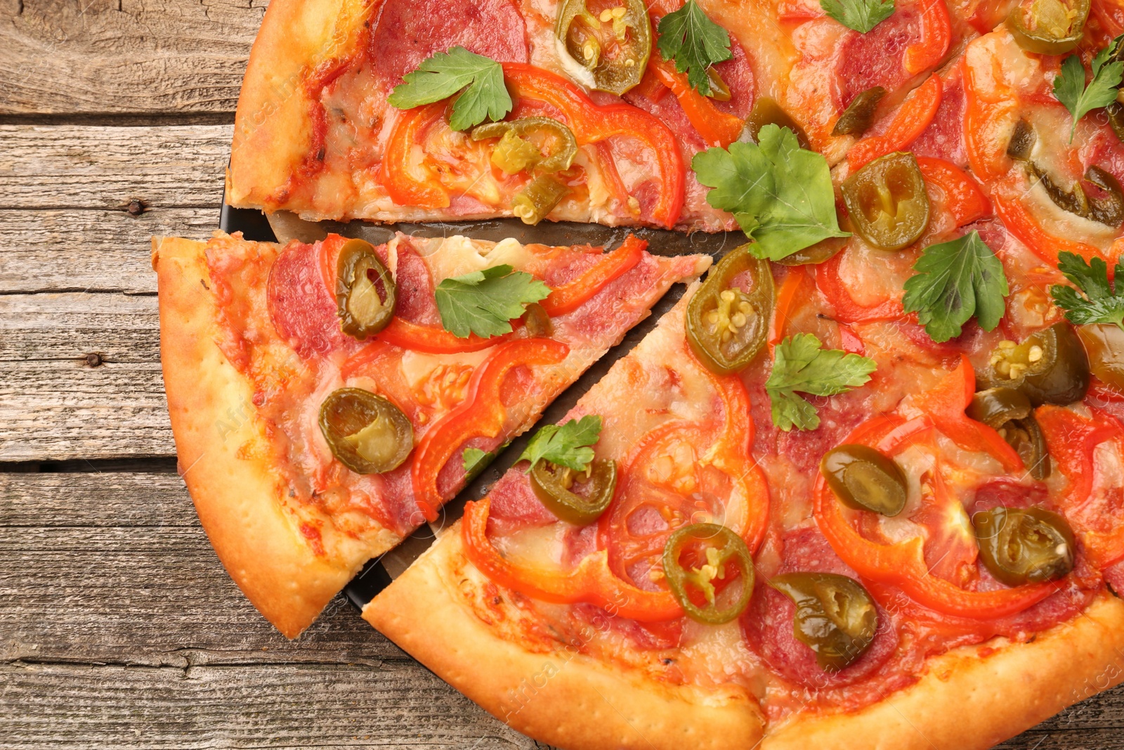 Photo of Delicious pizza Diablo on wooden table, top view