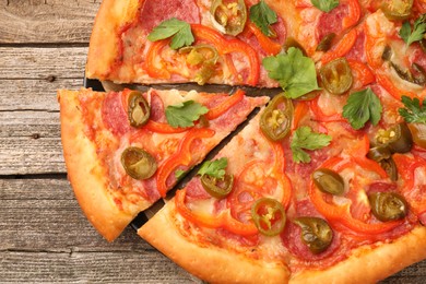 Photo of Delicious pizza Diablo on wooden table, top view