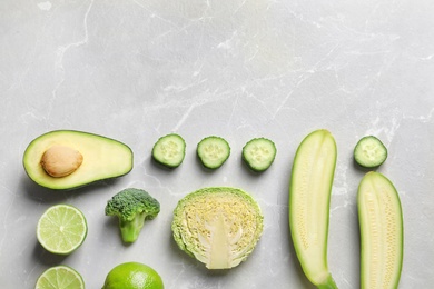 Flat lay composition with fresh vegetables and fruits on light background