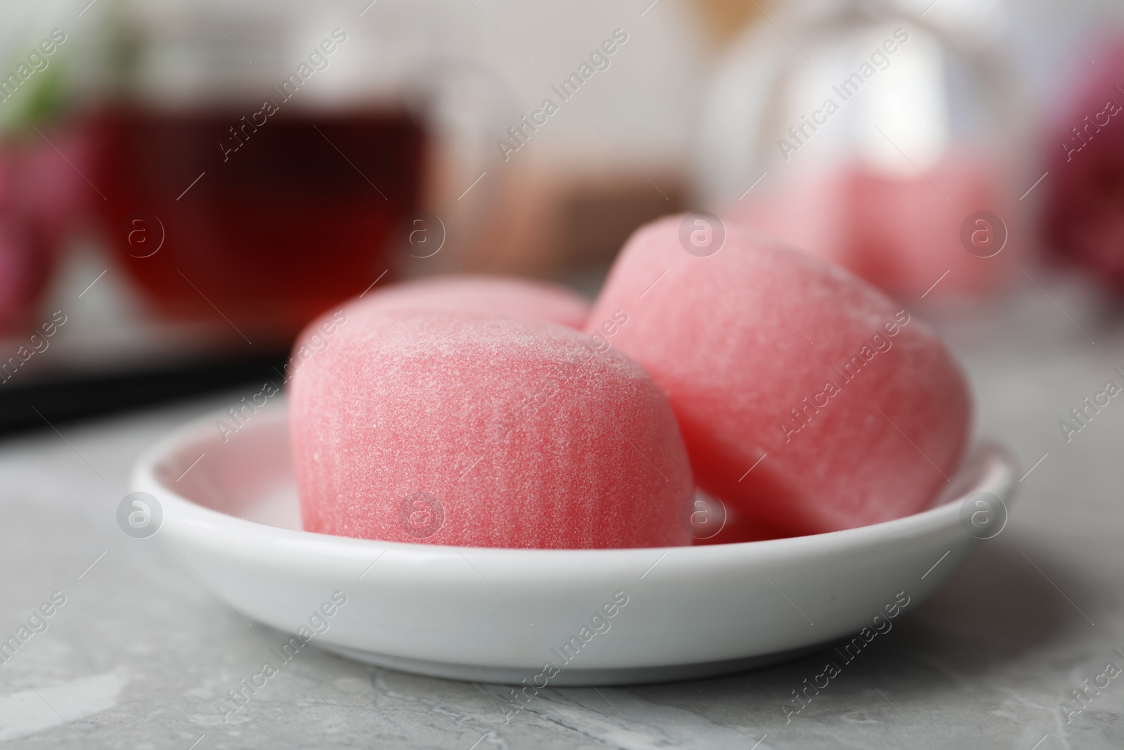 Photo of Plate with delicious mochi on grey table, closeup. Traditional Japanese dessert
