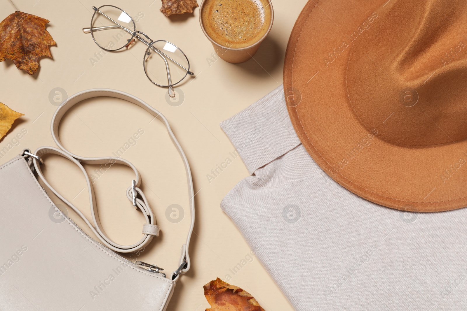 Photo of Flat lay composition with stylish hat on beige background