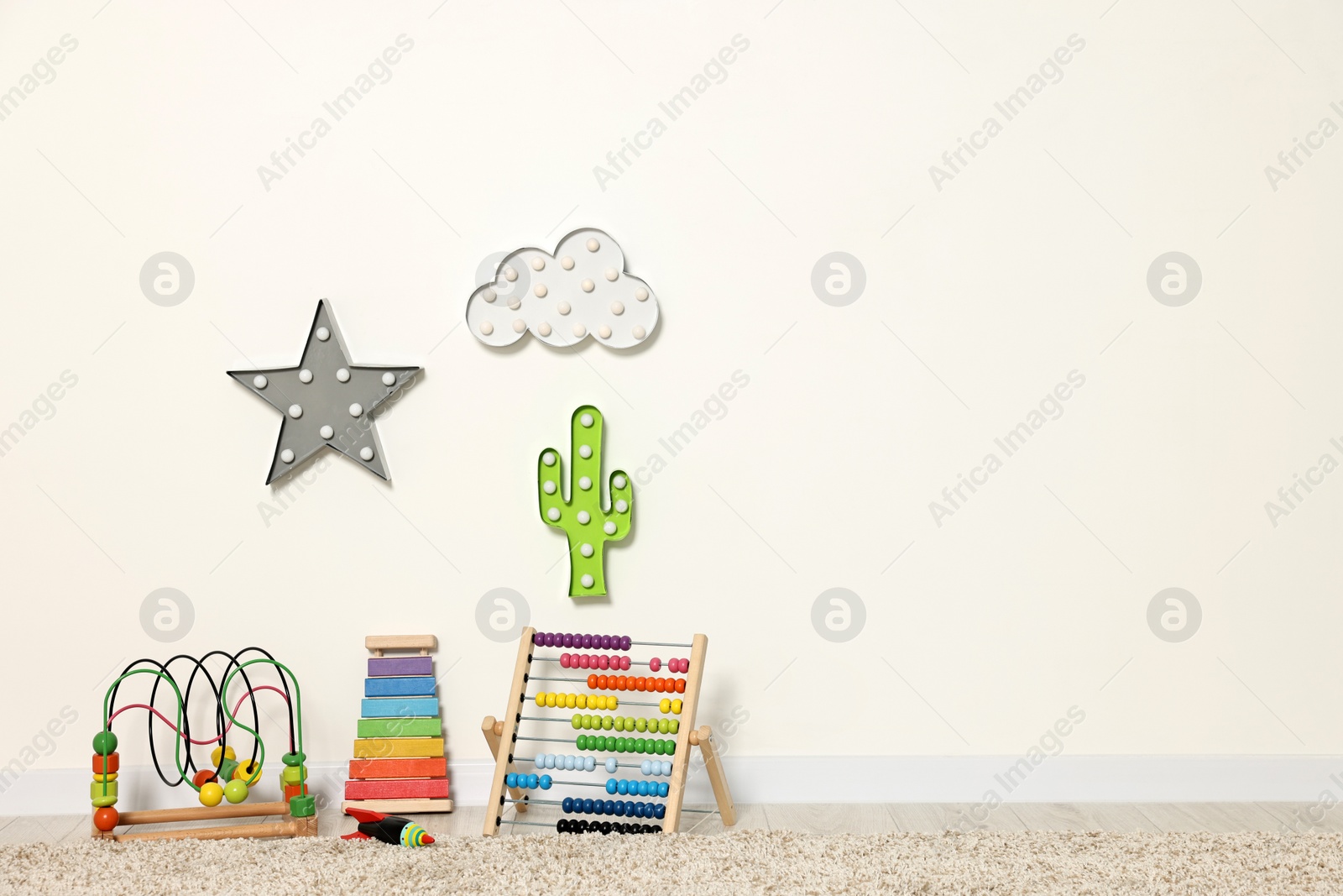 Photo of Educational toys and nightlights in beautiful children's room. Space for text