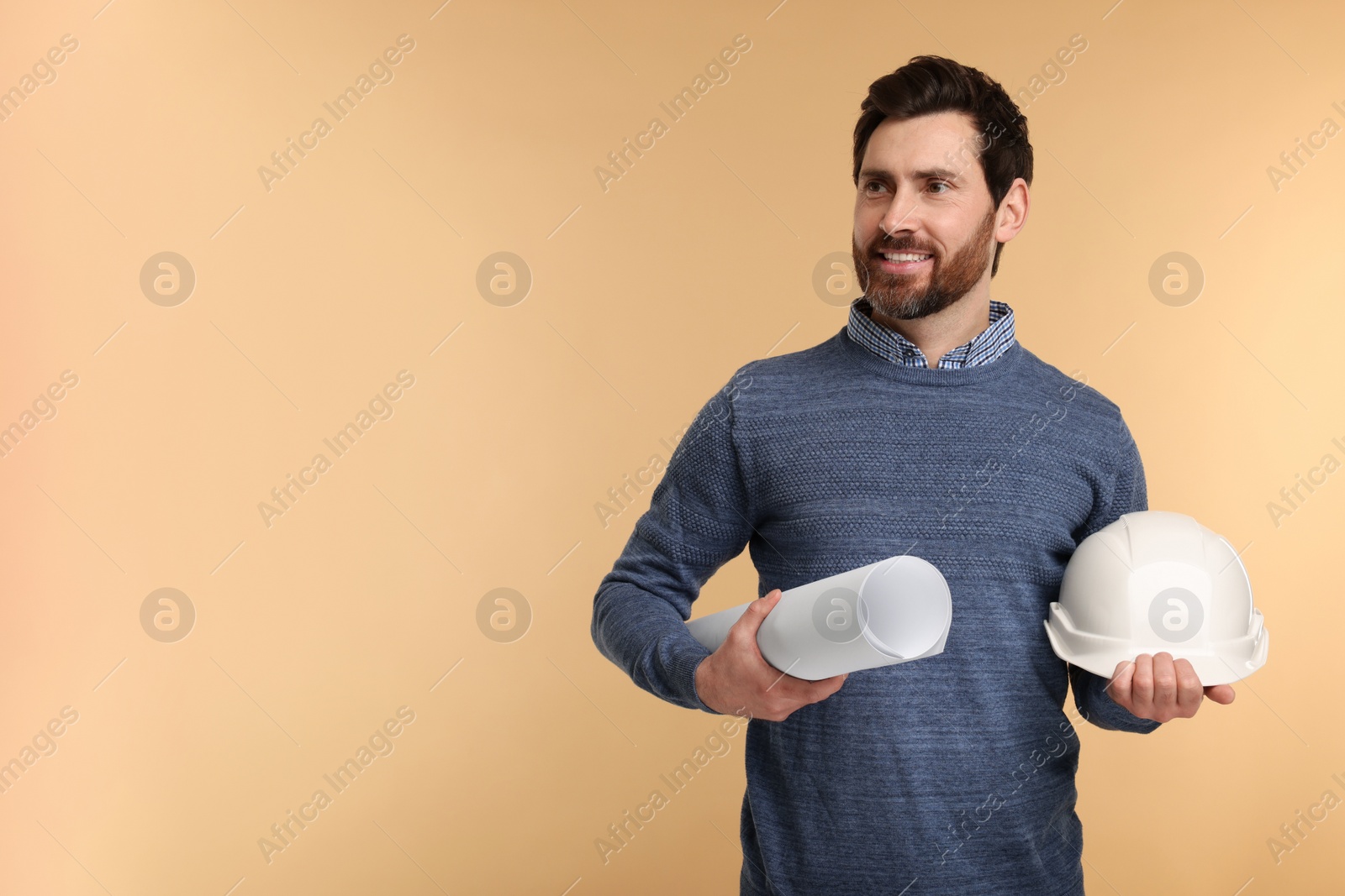 Photo of Architect with hard hat and draft on beige background, space for text