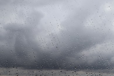 Photo of Water drops on window glass, closeup. Rainy weather