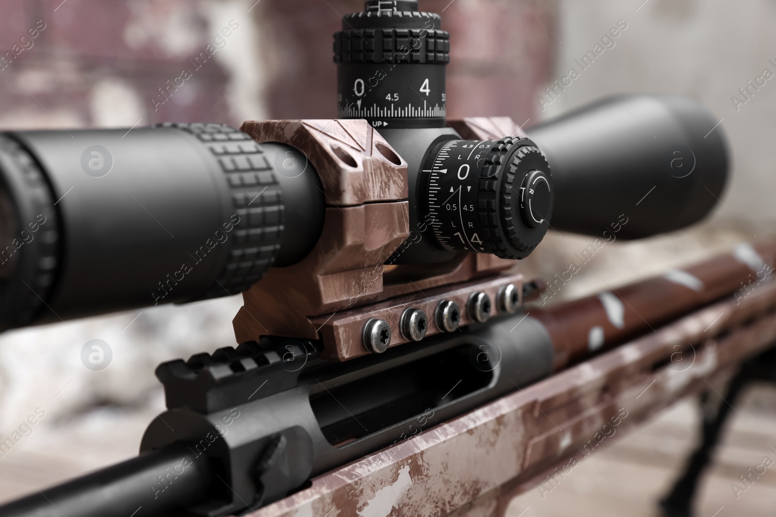 Photo of Closeup view of modern powerful sniper rifle with telescopic sight on blurred background