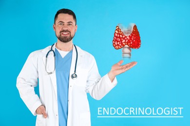 Image of Endocrinologist holding thyroid illustration on light blue background