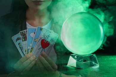 Image of Double exposure with crystal ball and photo of soothsayer with tarot cards