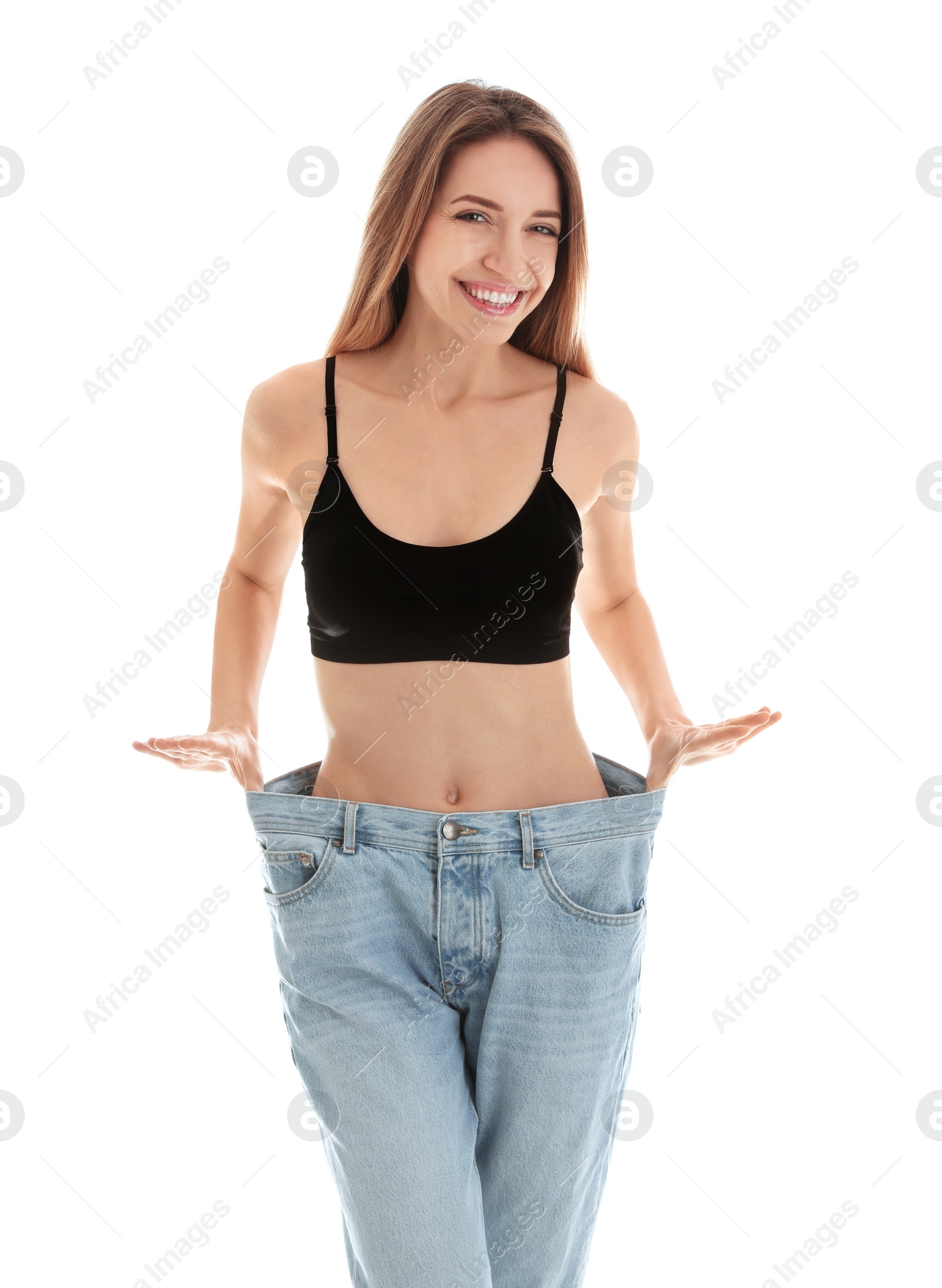 Photo of Slim woman in oversized jeans on white background. Perfect body