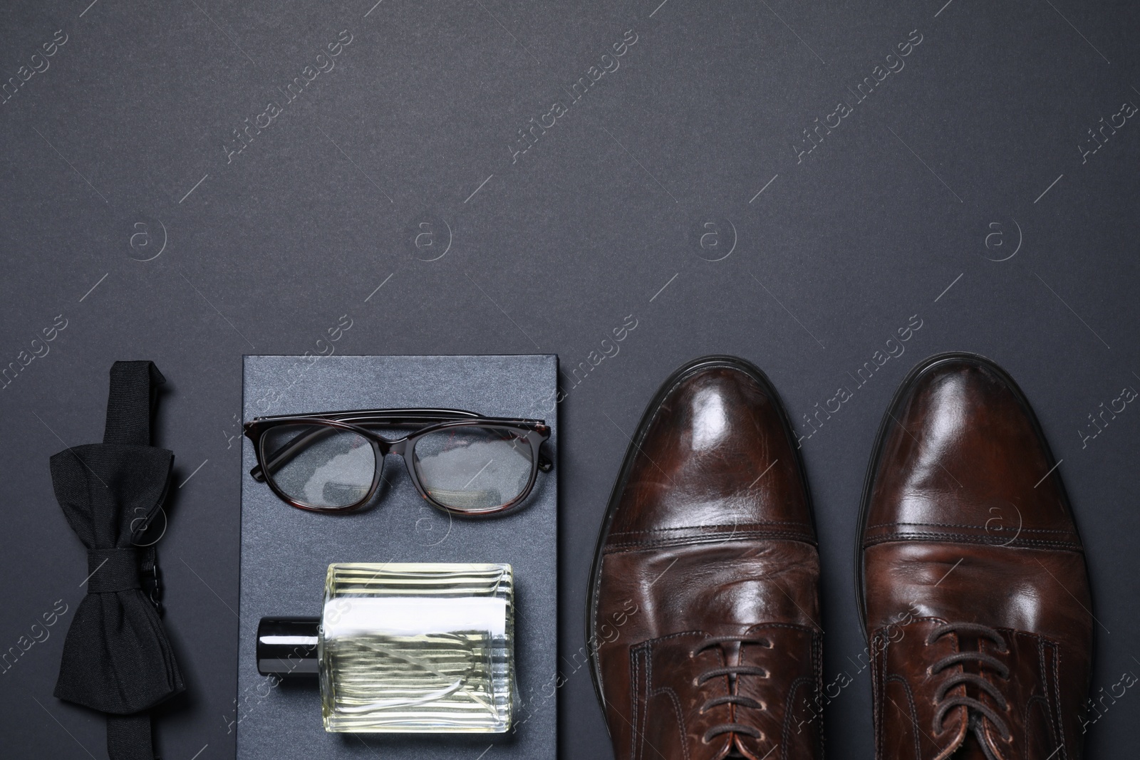 Photo of Set of men's accessories on dark grey background, flat lay. Space for text