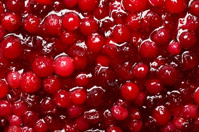 Photo of Fresh juicy cranberry sauce as background, closeup