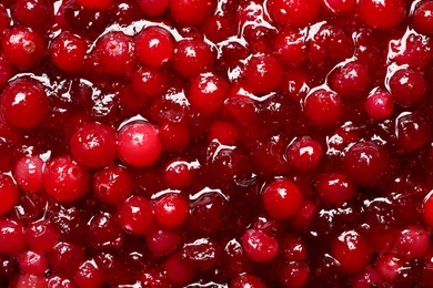 Fresh juicy cranberry sauce as background, closeup