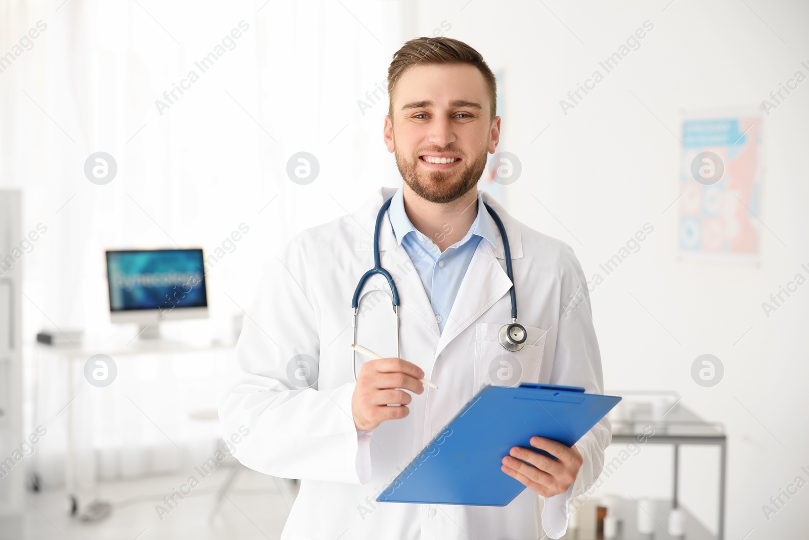 Photo of Young male doctor with clipboard in hospital. Gynecology consultation