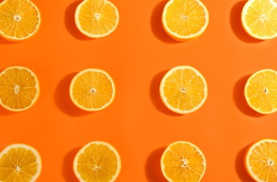 Slices of delicious oranges on color background, flat lay