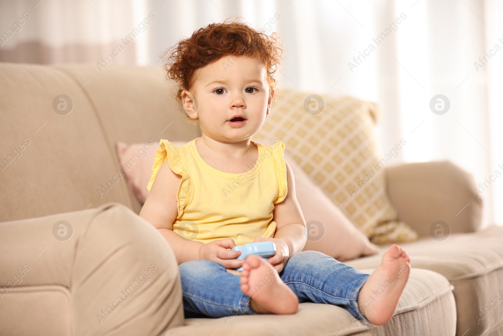 Photo of Portrait of cute little child on sofa at home