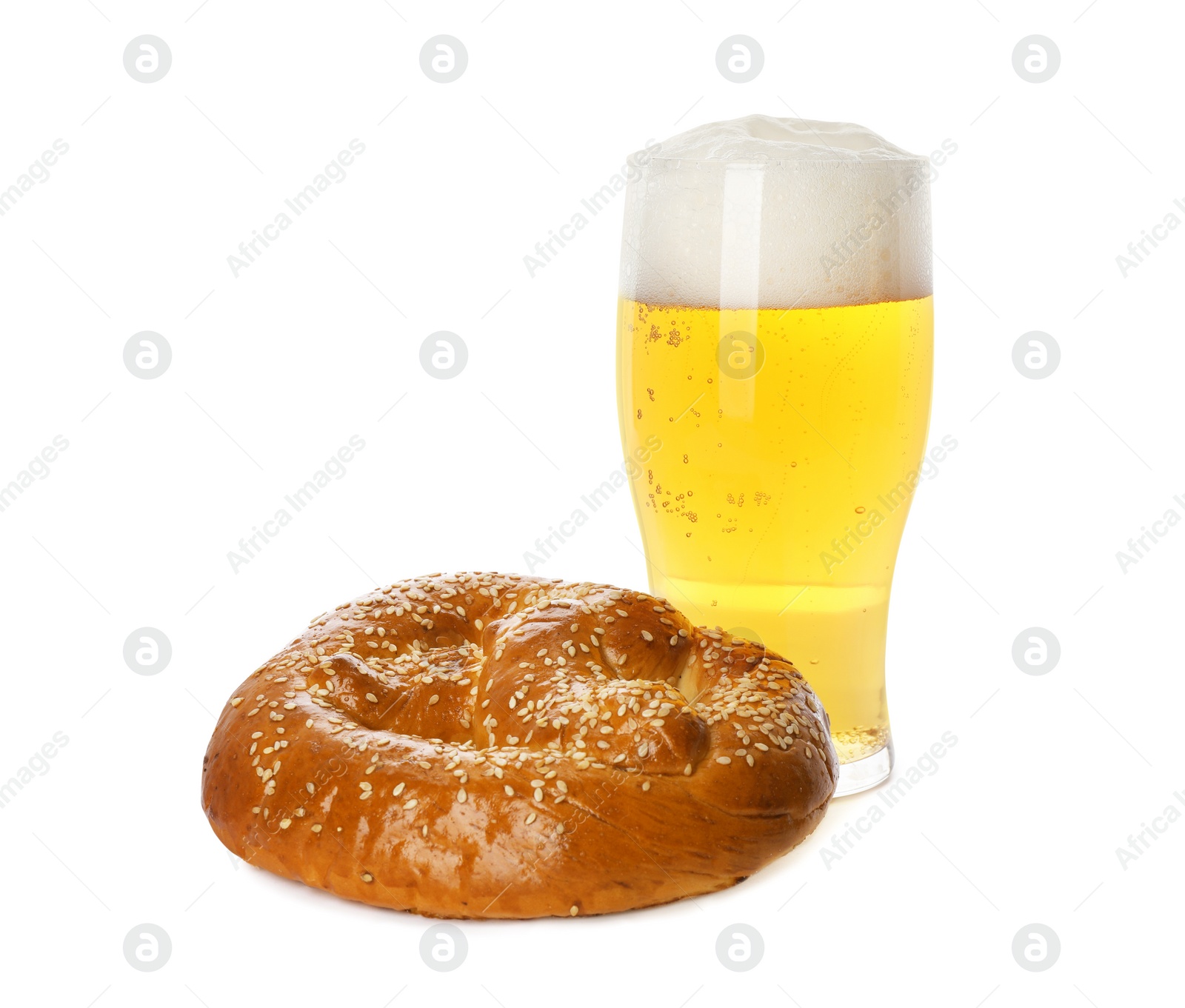 Photo of Tasty freshly baked pretzel and glass of beer on white background