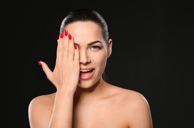 Photo of Portrait of beautiful young woman with bright manicure on black background. Nail polish trends