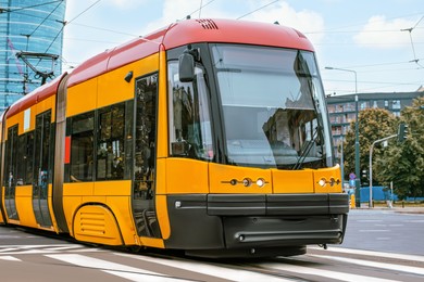 Photo of Modern tram on city street. Public transport