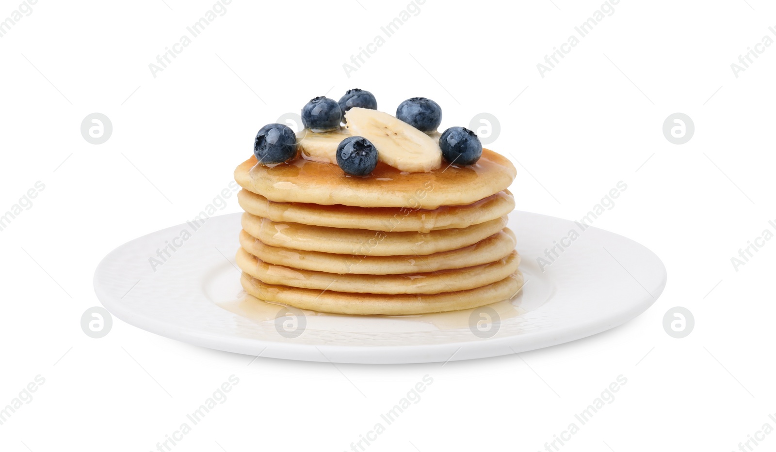 Photo of Delicious pancakes with banana slices, blueberries and honey isolated on white