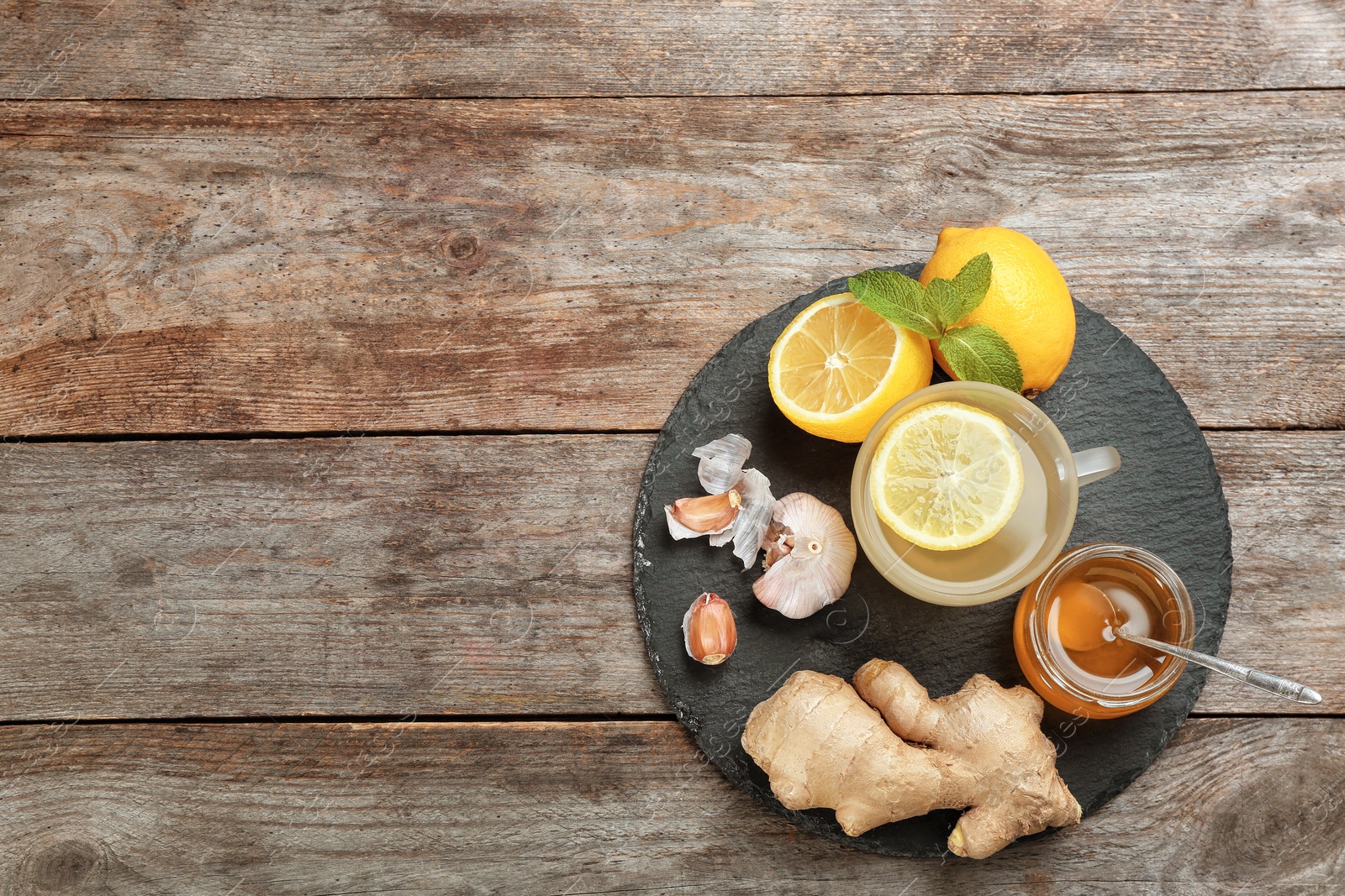 Photo of Slate plate with different cold remedies on wooden table, top view