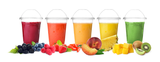 Image of Different delicious smoothies in plastic cups on white background. Banner design