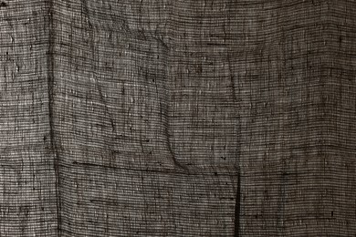 Photo of Texture of natural burlap fabric as background, closeup