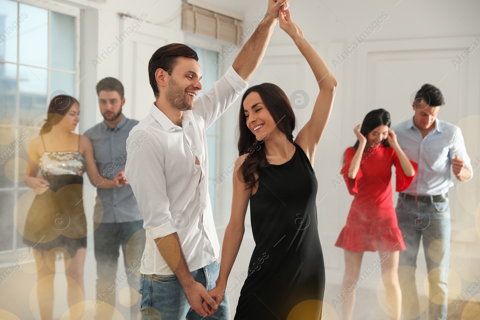 Photo of Lovely young couple dancing together at party