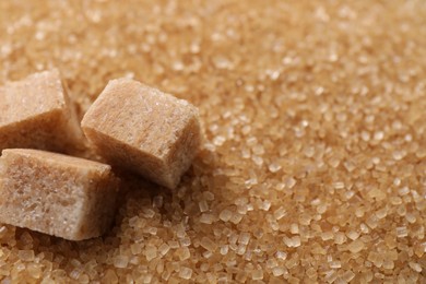 Different types of brown sugar as background, closeup. Space for text