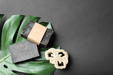 Photo of Flat lay composition with natural tar soap on black background. Space for text