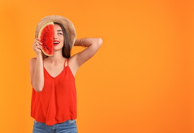 Beautiful young woman posing with watermelon on color background