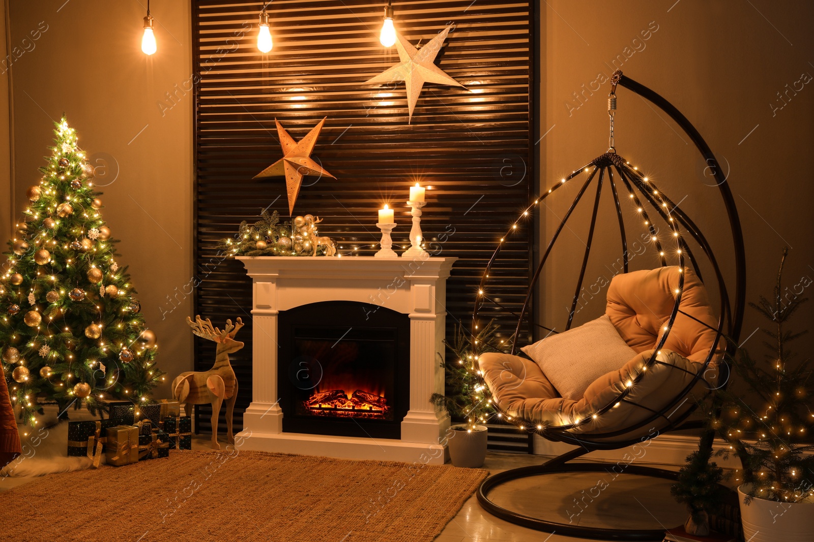 Photo of Beautiful living room interior with burning fireplace and hanging chair. Christmas celebration