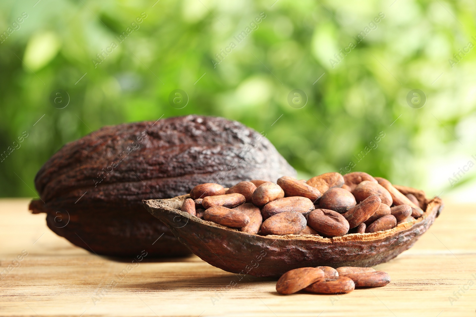 Photo of Cocoa pod with beans on wooden table