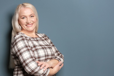 Photo of Portrait of beautiful mature woman on color background