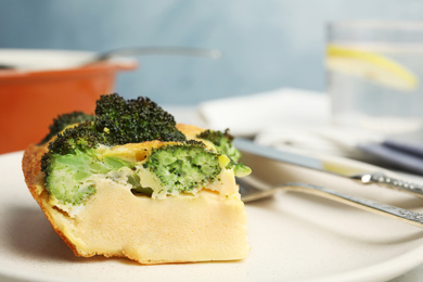 Tasty broccoli casserole on plate, closeup. Space for text