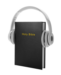 Photo of Bible and headphones on white background. Religious audiobook