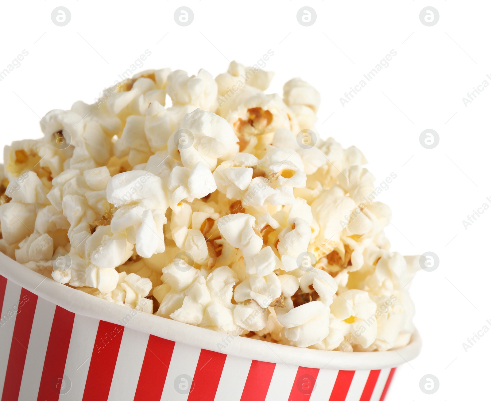 Photo of Delicious popcorn in paper cup isolated on white, closeup