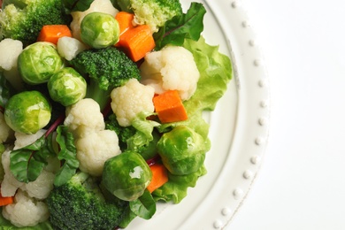 Plate of salad with Brussels sprouts and broccoli isolated on white, closeup