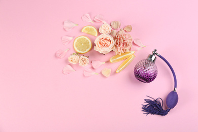 Photo of Flat lay composition with bottle of perfume on pink background