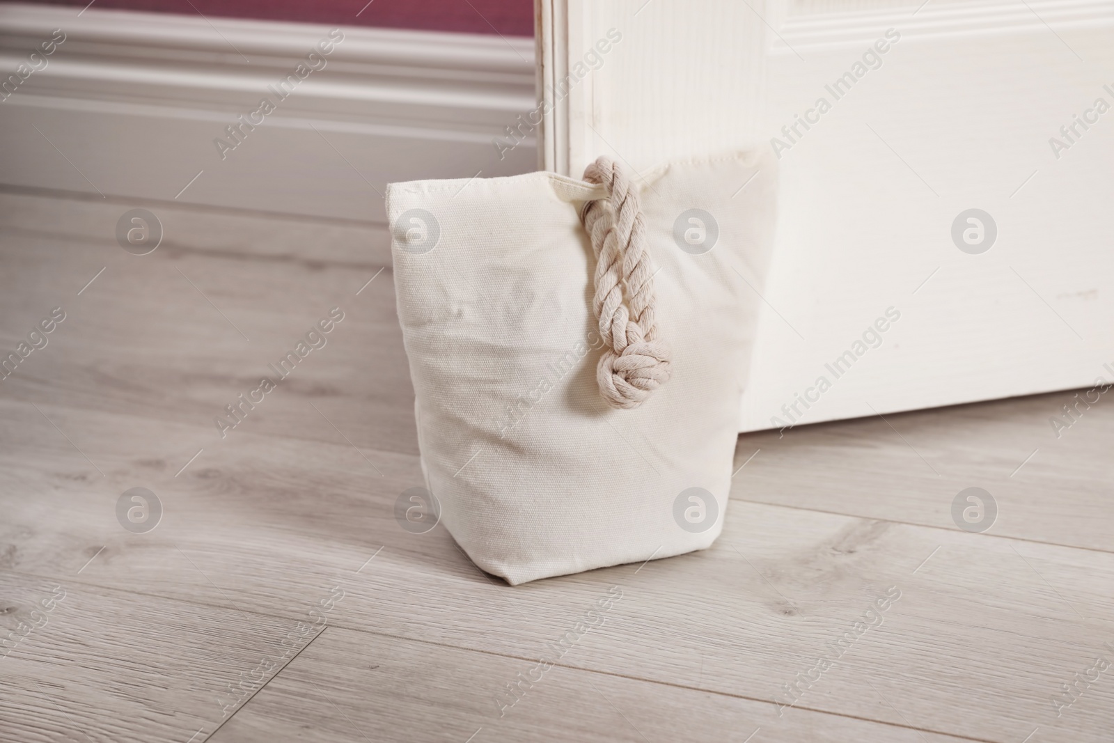 Stuffed bag holding wooden door at home Photo of Stuffed bag holding wooden door at home