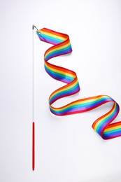 Photo of Rainbow gymnastics ribbon on white background, top view. LGBT pride