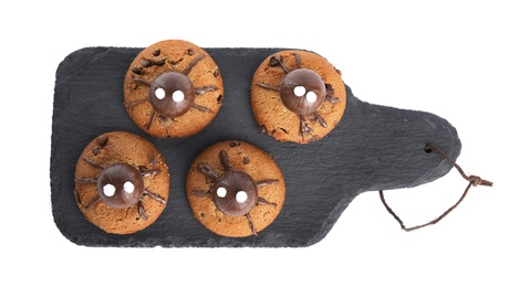 Photo of Delicious cookies decorated as monsters on white background. Halloween treat