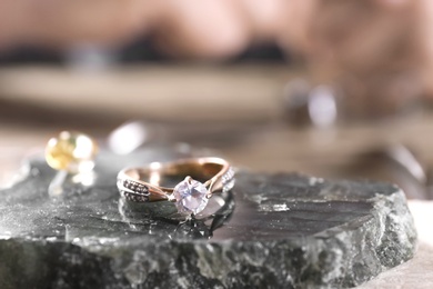 Diamond ring and blurred jeweler on background