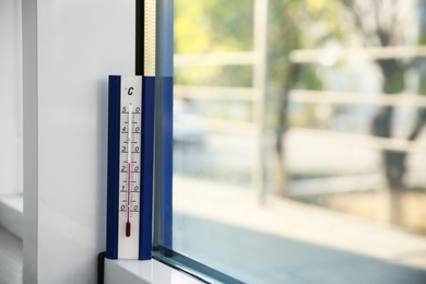 Photo of Weather thermometer near window indoors Space for text