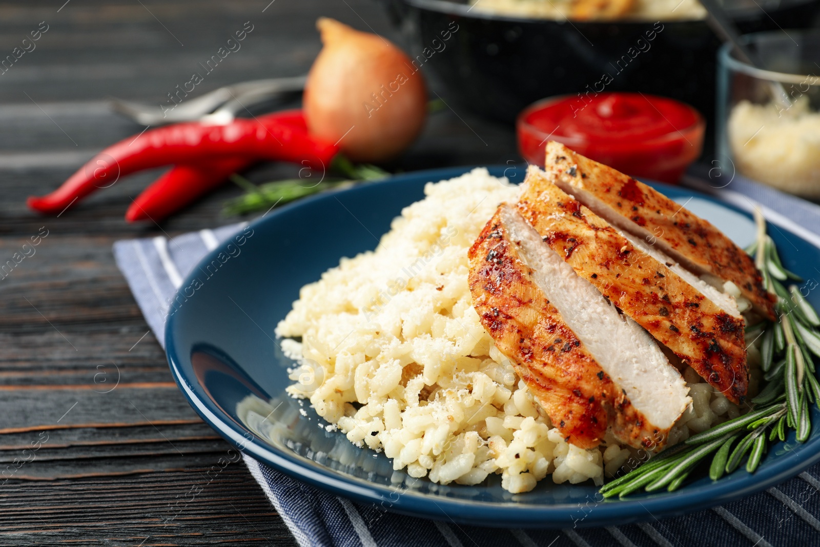 Photo of Delicious risotto with chicken on plate, closeup