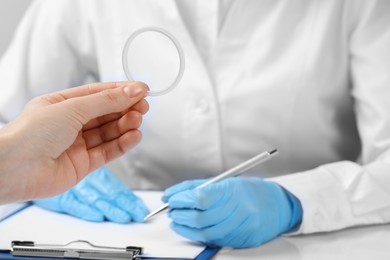 Photo of Woman holding diaphragm vaginal contraceptive ring at the doctor's appointment, closeup