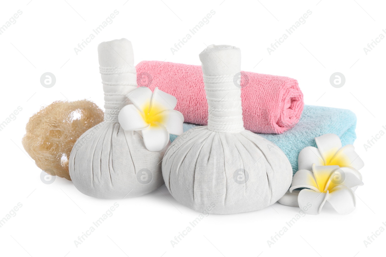 Photo of Herbal massage bags, towels, flowers and loofah on white background. Spa procedure